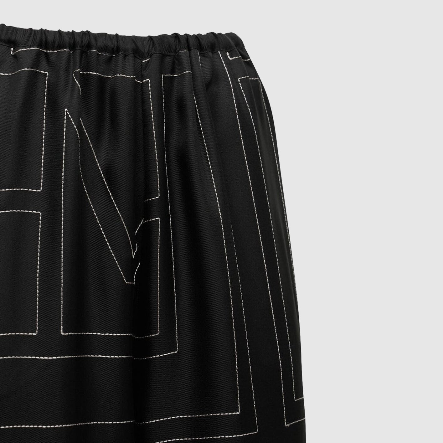 Monogram embroidered black silk pants